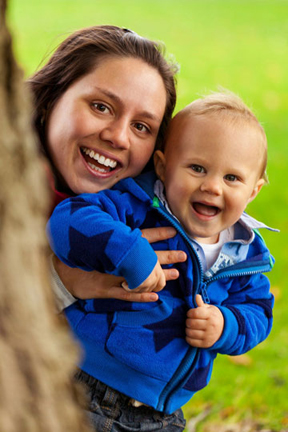 mom holding laughing baby photo